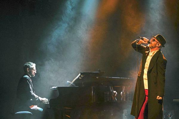 Strike the right chord: Former French football player and actor Eric Cantona performs at the Comedie Odeon Theatre in Lyon on Nov 3. — AFP