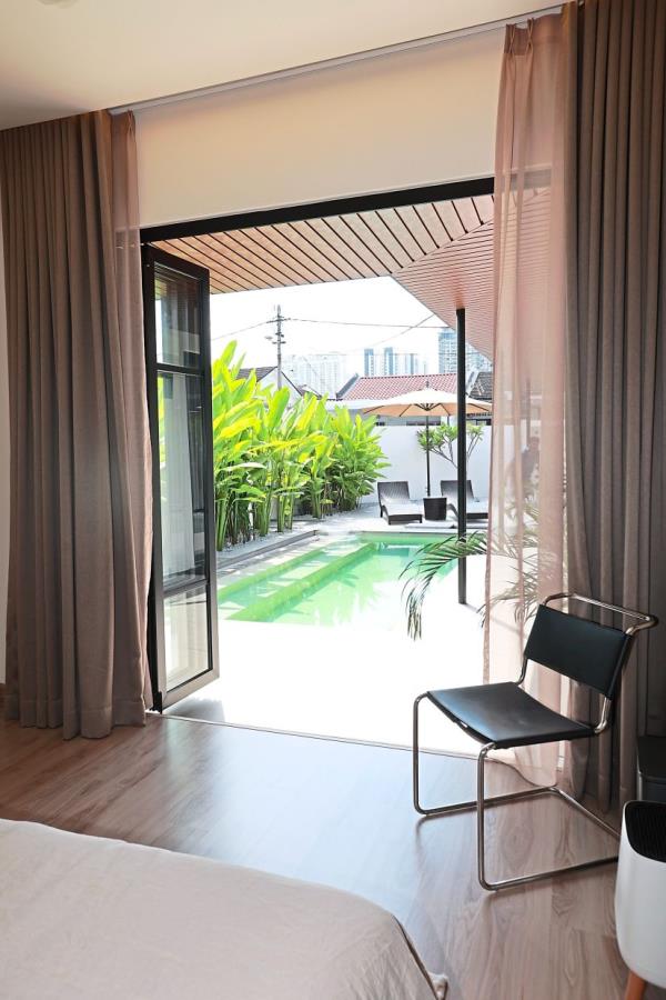 Tan’s bedroom looks out to the swimming pool and the outdoors.