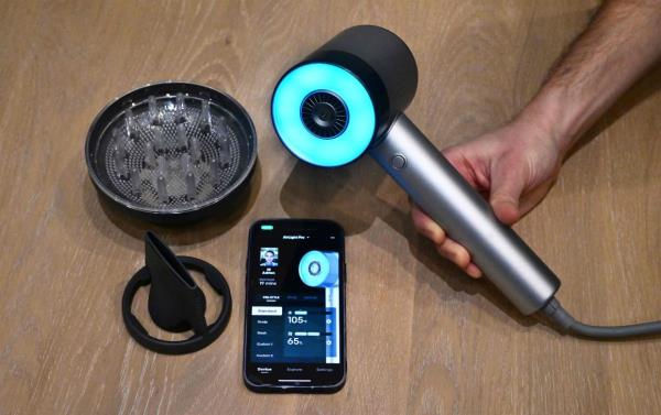 The L'Oreal AirLight Pro hairdryer, powered by patented infrared light technology, is displayed beside attchments for the hairdryer and a cellphone displaying the app at L'Oreal on January 7, 2024 at the 2024 Co<em></em>nsumer Electro<em></em>nics Show (CES) in Las Vegas, Nevada. The Airlight Pro uses infrared light to dry hair, increasing drying efficiency 30%, preserving the hair's moisture, and enables energy savings of 31% compared with a co<em></em>nventional appliance,  Adrien Chrétien, head of augmented beauty development at L'Oréal, explained to AFP. It is due to go on sale in April. — AFP