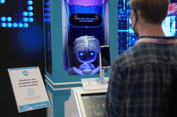 The AI analyses facial characteristics and produces an Tarot card-like print with a short, future-looking message or piece of advice. — AP