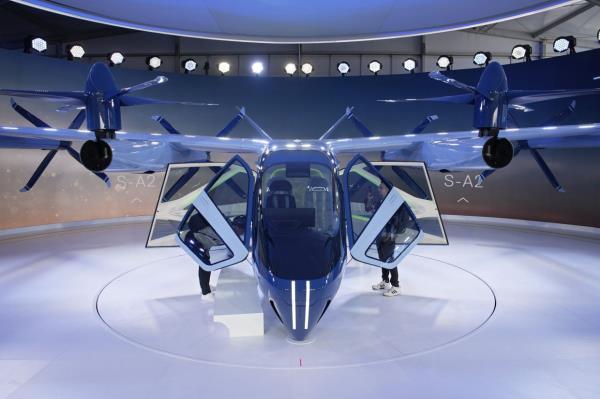 A person looks at the Supernal S-A2 passenger electric VOTL aircraft at the Supernal booth during the CES tech show in Las Vegas. Supernal is a part of the Hyundai Motor Group. — AP