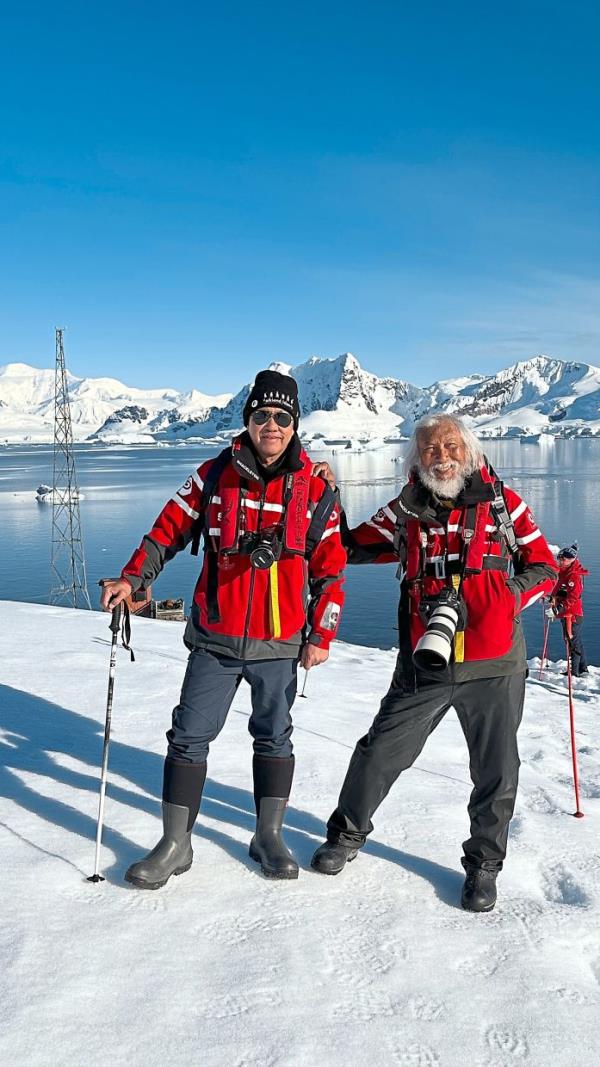The writer (left) keeping warm at Brown Station in Antarctica with Malaysian adventurer Yusuf Hashim. — FLORENCE TEH