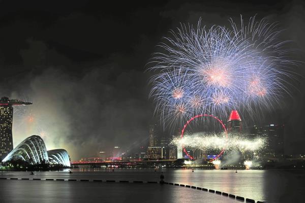 Colourful fireworks lighting up the Singapore skyline during a fireworks display.