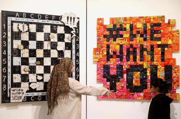 'Silent Conversations' (left) combines a chessboard game with a dialogue box, symbolising the ongoing battle between human progress and the environment, while 'The Allure Of More II' (righ) highlights modern day consumerism and greed. Photo: The Star/Azlina Abdullah 