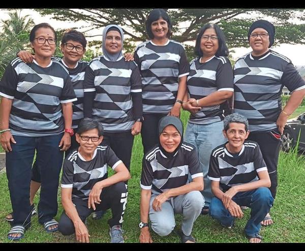 Bosom buddies: Normala Rashid (front row, middle) reunited with her old natio<em></em>nal teammates before a friendly match.