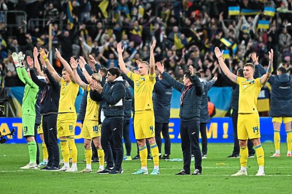 Ukraine players celebrate with their fans after qualifying for the Euro 2024 finals in Germany. — AFP