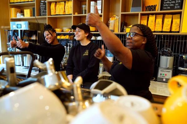 Cafe manager Shray Campbell (left), with chef Ariel and assistant manager Sarah greet customers at Cafe Joyeux.