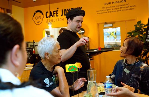 Gideon serves customers at Cafe Joyeux's Midtown location in the Manhattan borough of New York City.