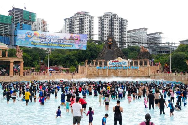 Guests enjoying Sunway Lagoon’s newest attraction, the Surf Pool and Pink Island at Surf Beach.