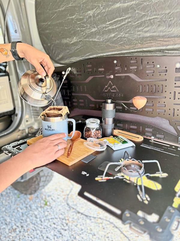 The rear door of the Suzuki Jimny can be fitted with a flip-open table for myriad uses.