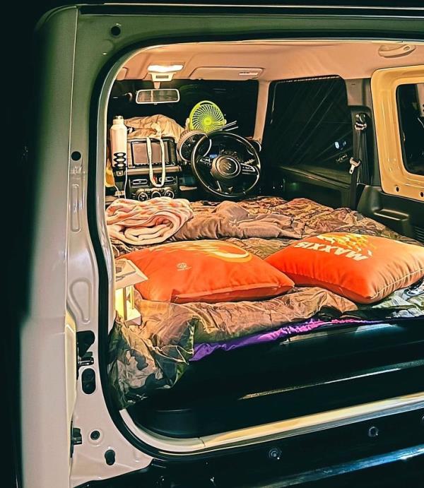 Suzuki Jimny’s seats can be folded flat to create a bed space for two.