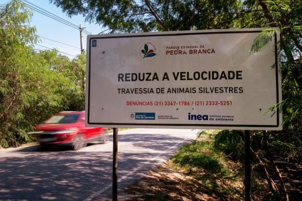 A sign reading in Portuguese ‘Reduce speed, wild animals crosspath’ is pictured at Roberto Burle Marx road in west Rio de Janeiro on April 17, 2024. — AFP