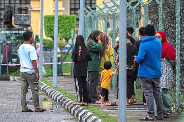The victims family members awaiting news at the hospital grounds. — Bernama