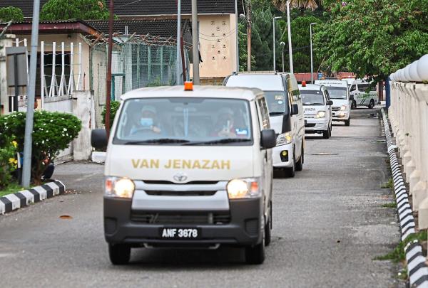 Sombre mood: A van carrying the remains of the victims of the helicopter crash arriving at Hospital Raja Permaisuri Bainun in Ipoh. — Bernama