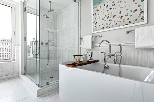 Polished chrome fixtures add a traditional and timeless touch to this master bathroom.