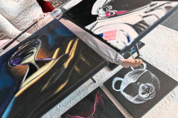 For Rajacenna, every paint stroke is worked out in advance in her head before setting to work with hands – and feet. Photo: AFP 