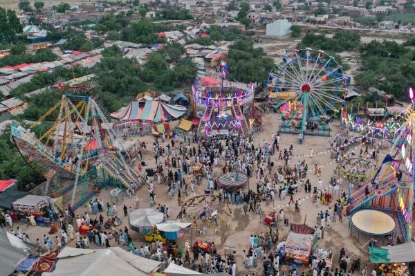 As the harvest season ends and schools finish for the summer, villagers climb atop tractor trolleys, buses, and rickshaws to head to the annual celebrations at Sufi shrines dotted across the country. Photo: AFP