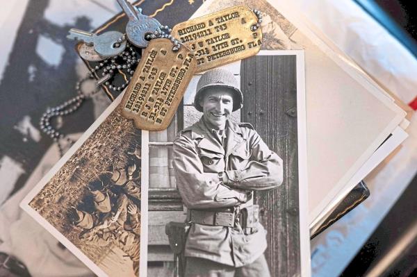 Photos, dog tags, documents and a uniform that belonged to Taylor. — AFP