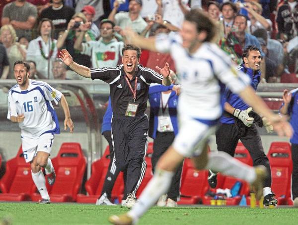 Greek ecstasy: Greece’s German coach Otto Rehhagel (centre) reacts as his players rejoice after stunning Portugal 1-0 to win the Euro 2004 final in Lisbon. — AFP