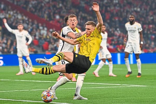 Real’s Toni Kroos (left), who will retire, fights for the ball with Dortmund’s Nico Schlotterbeck. — AFP