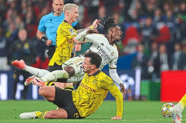 Real’s Eduardo Camavinga goes flying after a tackle by Dortmund’s Mats Hummels. — AFP