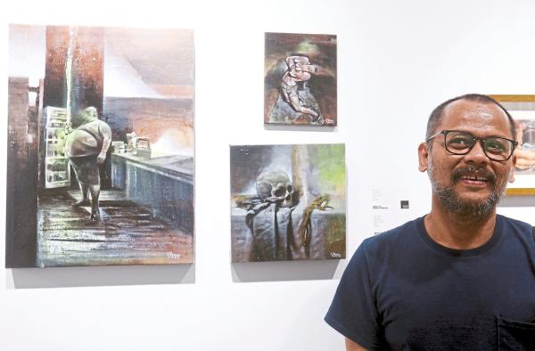 Ilham Fadli, also known as Kojek, drew inspiration from M. Nasir's 1992 song 'Apokalips' to create his new series of paintings. Photo: The Star/Azlina Abdullah 