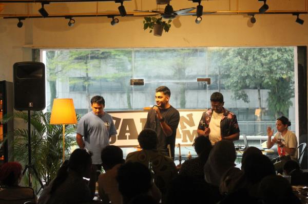 Poet and co-founder of Jalan Dalam, Raaja Rao (centre), urges the crowd to decide the winner during a recent poetry slam. Photo: Handout 