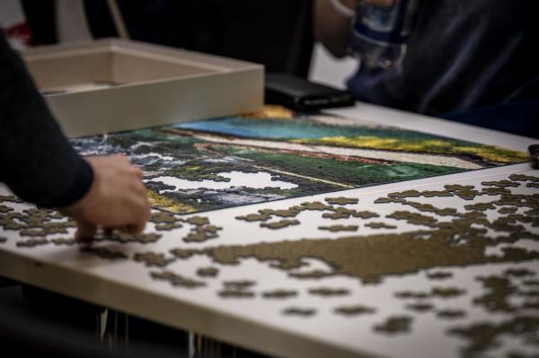 During breaks, participants solve puzzles with 1,000 or more pieces.