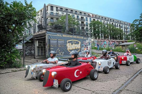Refreshing change: Fans enjoying a drive in mini cars ahead of the final between Spain and England in Berlin.— AP