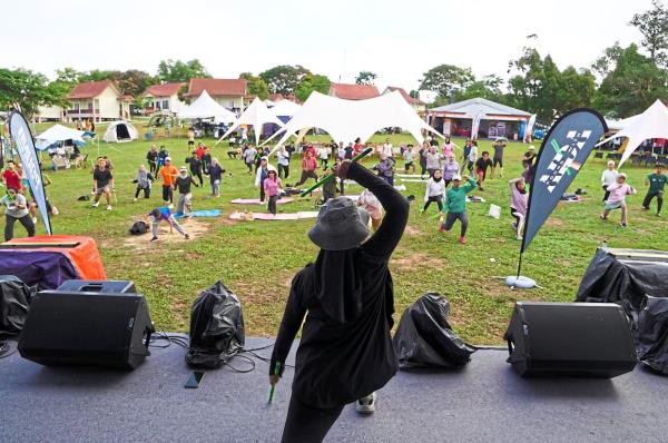 An instructor leading participants on a pound dance session.