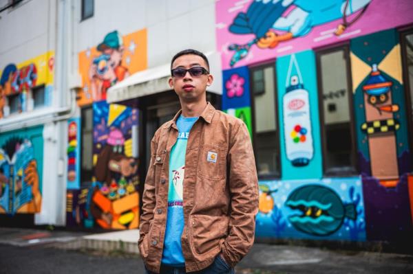 Cloakwork poses in front of his work on a street in Tokyo, Japan wher<em></em>e he is currently participating in a graffiti tour. Photo: Alff
