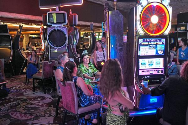 People playing slot machines at the hotel-casino a day before it closed.