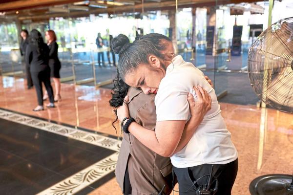 Long-time porters Vero<em></em>nica Urbina (left) and So<em></em>nia Martinez hugging on the final day of operations at The Mirage. — Photos: AP