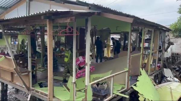 Enforcement officers demolishing the squatter homes