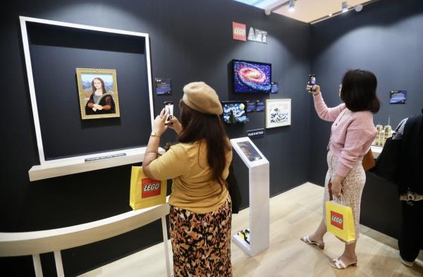 Visitors take photos of the brick artworks on display at the Lego Parisian Cafe and Art Gallery pop-up The Exchange TRX in Kuala Lumpur. Photo: The Star/Shaari Chemat
