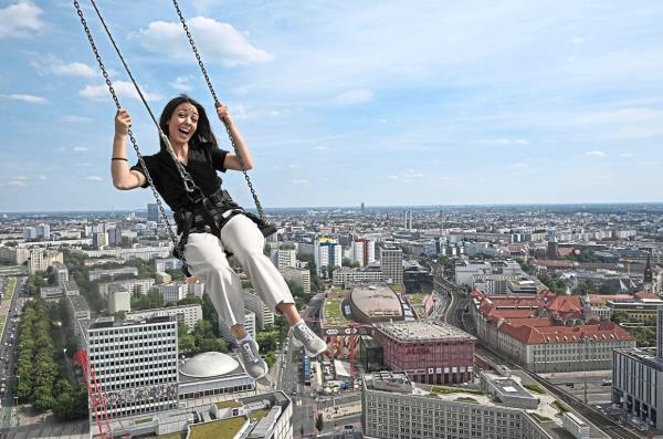 Sorice happily swinging on a structure hanging from a hotel in Berlin. — AFP
