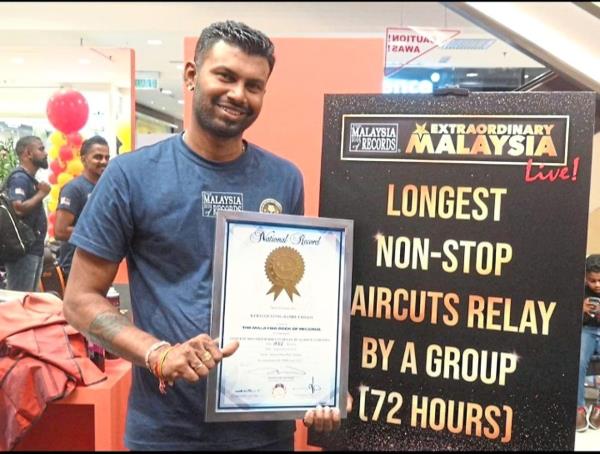 Kalitasan holding the certificate for 'Lo<em></em>ngest Non-Stop Haircuts Relay By A Group in 72 Hours'. Next, he will attempt another record by giving free haircuts for 96 hours non-stop.