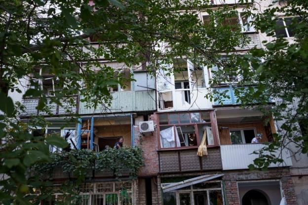 Residents of Pokrovsk, Ukraine, are seen clearing glass from their balco<em></em>nies on Tuesday, in the aftermath of Russian bombardment.