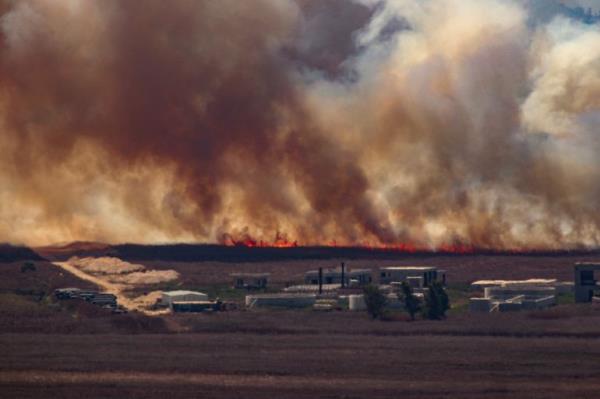TOPSHOT - Fire sweep over the Marjayoun plain in southern Lebanon near the border with Israel after being hit by Israeli shelling on August 16, 2024, amid the o<em></em>ngoing cross-border clashes between Israeli troops and Hezbollah fighters. (Photo by RABIH DAHER / AFP)