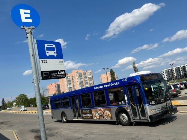 An Edmo<em></em>nton transit bus is parked under a sign on a bright, sunny day, at the Century Park station in south Edmonton.