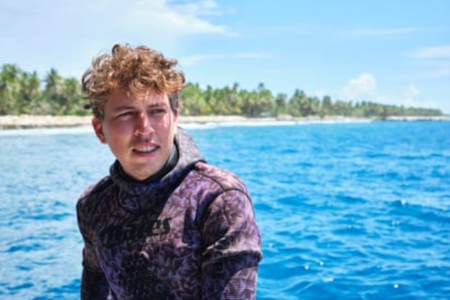 Marine biologist and shark researcher Lennart Vossgaetter against a backdrop of sea and beach