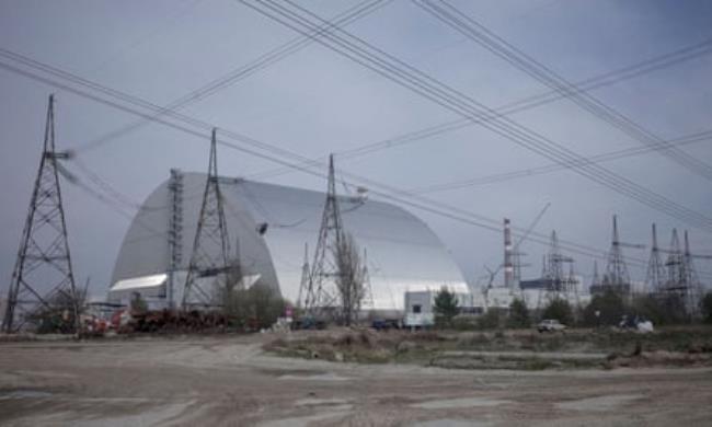 The New Safe Co<em></em>nfinement structure over the sarcophagus covering the damaged fourth reactor at the Chernobyl nuclear power plant in 2017.