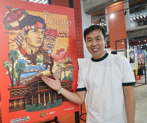 Thomas Wee aka 'Thomasupernova' poses with his movie poster creation 'The Kelate Kid' during the launch of the exhibition at Semua House in Kuala Lumpur. Photo: The Star/Azman Ghani
