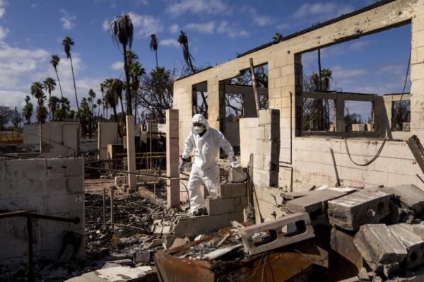 FILE - Rev. Ai Hironaka, resident minister of the Lahaina Ho<em></em>ngwanji Mission, walks through the grounds of his temple and residence destroyed by wildfire, Thursday, Dec. 7, 2023, in Lahaina, Hawaii. (AP Photo/Lindsey Wasson, File)