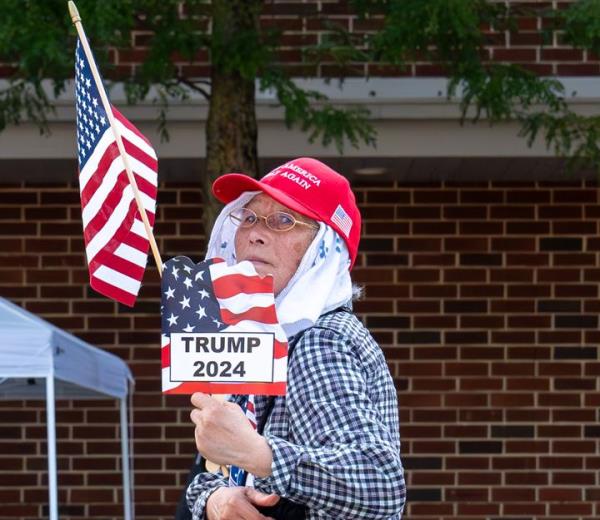 A vendor looks at his table of merchandise outside a rally for Trump in Johnstown.