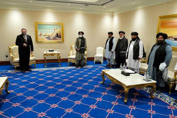 Then-U.S. Secretary of State Mike Pompeo, left, meets with Mullah Abdul Ghani Baradar, second from left, and members of the Taliban's peace negotiation team, in Doha, Qatar, on Nov. 21, 2020.