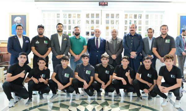  The Pakistan Street Child Football Team, which took part in the Norway Cup, is pictured with PM Shehbaz Sharif in Islamabad, on Wednesday.—APP 
