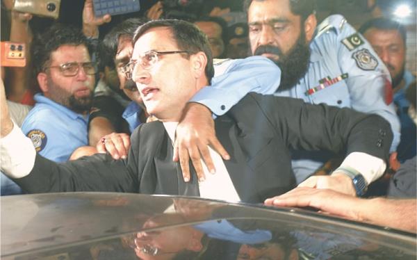  PTI leader Barrister Gohar Ali Khan is bundled into a vehicle by police perso<em></em>nnel following his arrest, outside the Parliament House on Mo<em></em>nday night.—Mohammad Asim / White Star 