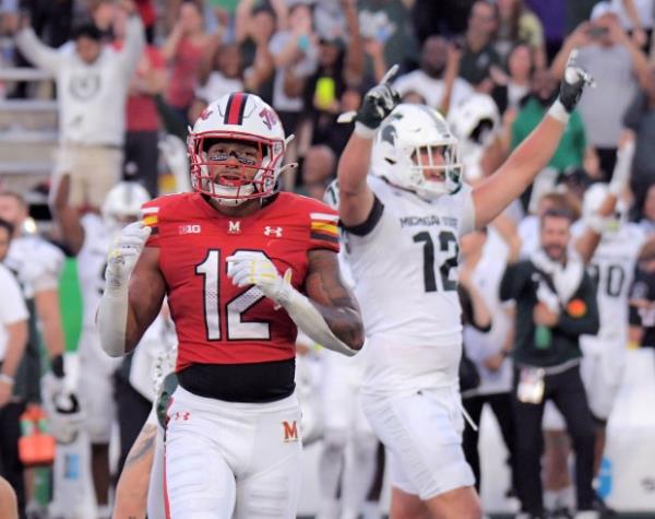 Maryland Terrapins defensive back Dante Trader Jr. walks off while Michigan State Spartans tight end Jack Velling punches the sky after kicker Jo<em></em>nathan Kim scores a field goal to break a tie game during the first Big Ten game of the season in College Park. Michigan State upset the Terrapins, 27-24. (Karl Merton Ferron/Staff)