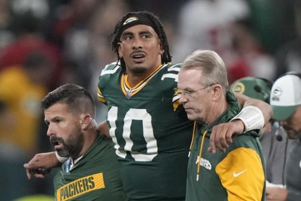 Packers quarterback Jordan Love in helped off the field after suffering a knee injury during the closing seco<em></em>nds against the Eagles on Sept. 7, 2024, in Sao Paulo. (Doug Benc/AP)